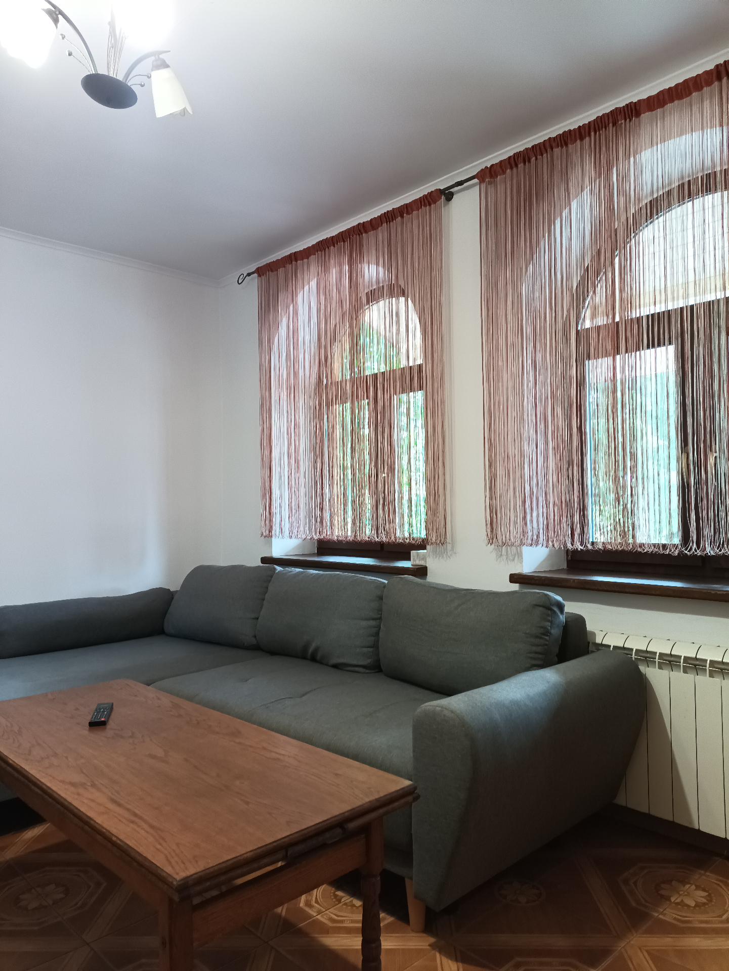 Domek 9 — salon z dużą narożną sofą przy oknach